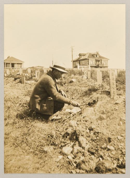 [Man attending to gravestone in Chinese cemetery in Victoria, B.C.]