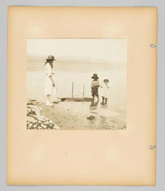 [Children playing with toy boat on shore, page 34 of Children album]