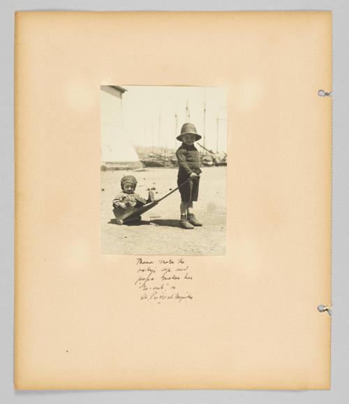 Mama makes the baby's cap and papa makes her "go-cart" in St. Pierre et Miquelon [Page 26 of Children album]
