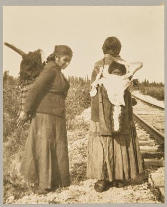 Cree babies tucked away in their gay-colored "tikinagans" at the Pas, Manitoba

