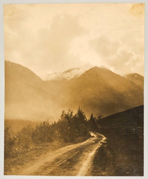 [Vehicle tracks on a winding mountain road]