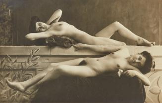 [Two reclining women, one holding flower in hand]
