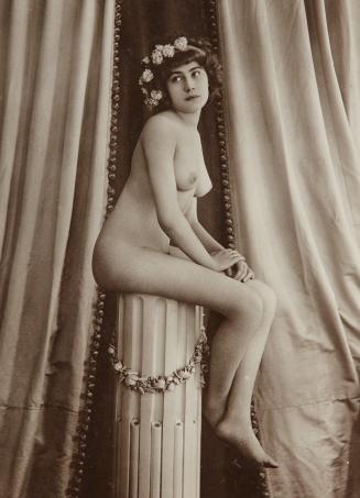 Woman seated on pedestal