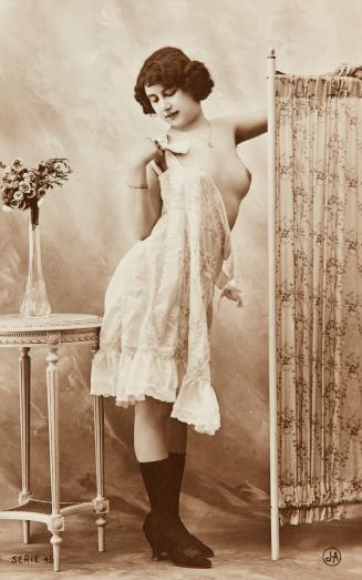 [Woman with screen and flowers on table]
