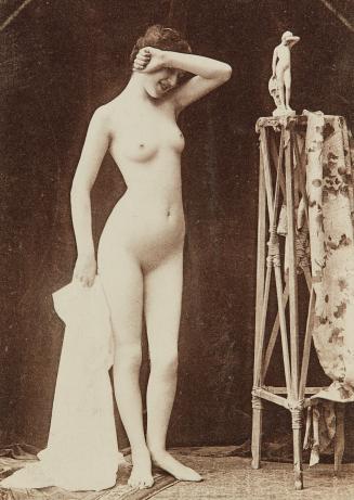 [Standing woman striking pose of sculpture on stand]