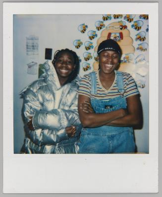 [Two girls posing, one in bright silver puffy coat]

