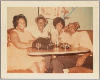 Brenda [Two women and two men posing in restaurant booth]
