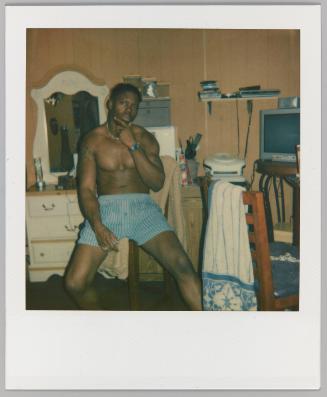 [Man in boxers seated with cigarello in hand]
