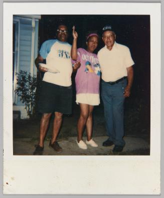 [Two men and woman, man on left in 'Super Dad' graphic t-shirt]
