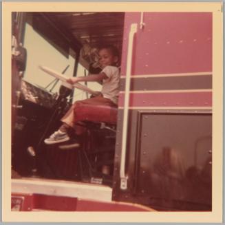 [Little boy in drivers seat of large vehicle]
