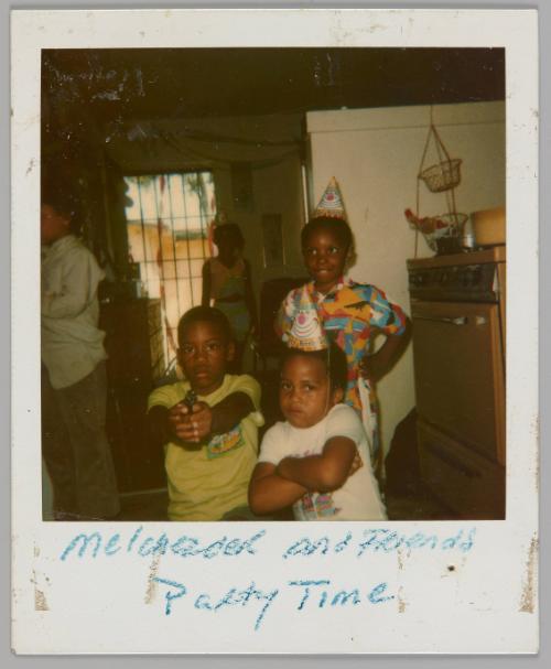 [illeg.] and Friends Party Time [Three boys posing together, two are wearing party hats and boy on left is mimicking pointing gun with his hands]