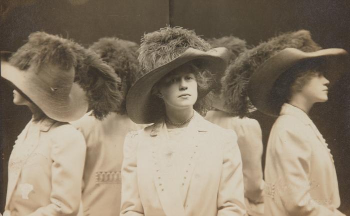 [Young woman with feathered hat]