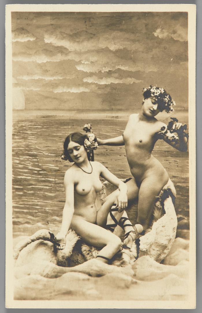 [Two women with flowers in hair, seashore setting]