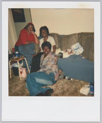 [Three women gathered around one side couch]