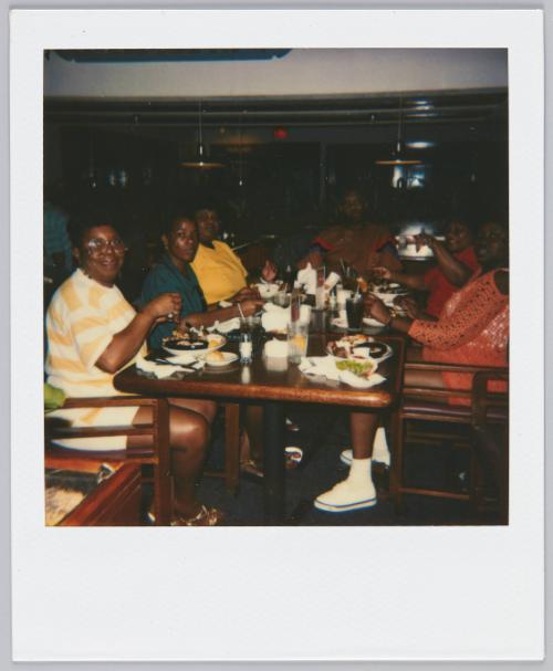 [Group sitting at restaurant table mid-meal]