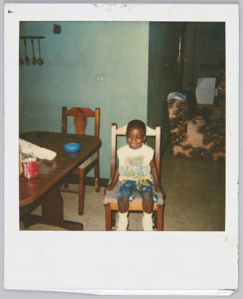 [little boy sitting on dining room chair wearing Lounge Lizard tank]