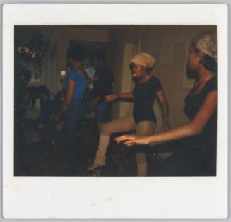[Women dancing, woman in centre wearing a leotard and tights]
