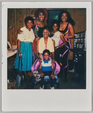[Group of six posing, three young women are dressed up in flashy leotards]