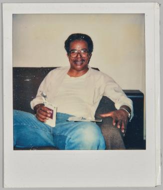 [Older man in big glasses stirring on couch]
