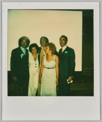 [Group of three men and two women posing in formal apparel]
