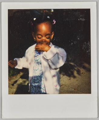 [Little girl in pink sweater with sleeves rolled up]
