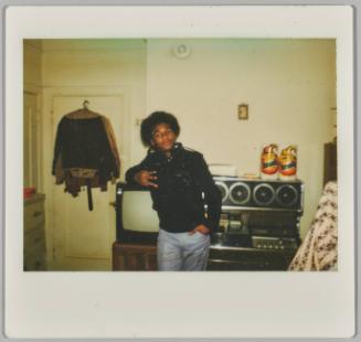 Jordans High [Man making hand gesture, leaning against television]
