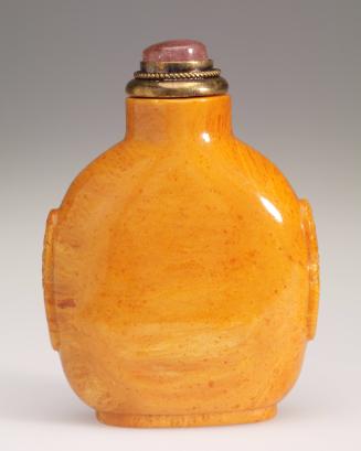 Snuff bottle in amber with mask and ring handles