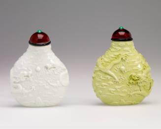 One of a pair of snuff bottles in green porcelain with two dragons
