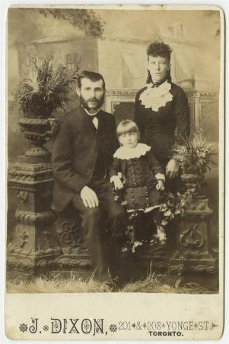 [Family portrait with seated child]