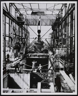 A 165 ton pressure vessel is lowered in to the Shipping port atomic power plant.