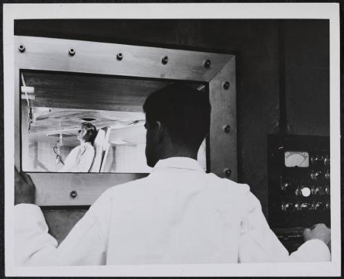 A model takes position in the medical facility room directly beneath the core of the new Massachusetts Institute of Technology nuclear reactor in Cambridge, The opening above her head admits radiation controlled by the operator outside the room