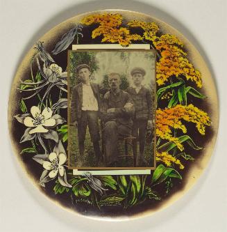 [Portrait of man with two young boys, with floral decorations]
