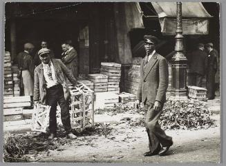 A young man returning from an evening of fun, passes a workman in the early morning hours.
