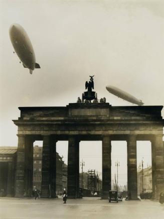 Zeppelin 129 and Zeppelin 127 over Berlin during their German tour. The air giants fly above the Brandenburg gate..
