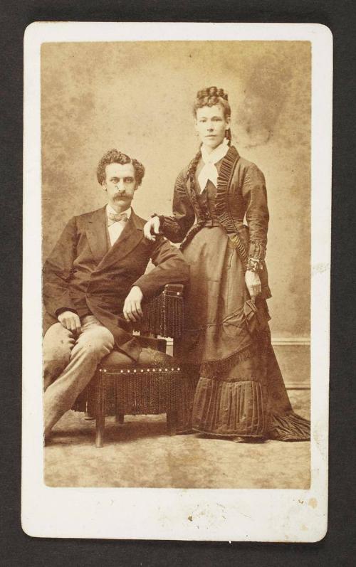Unknown sitters [portrait of a seated man and standing woman, with her right hand on man's left shoulder]