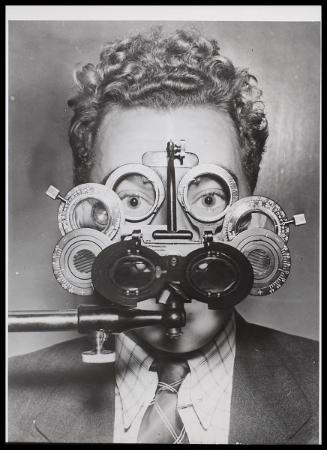Headshot of man at eyesight testing apparatus.