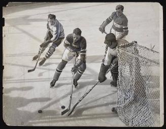 U.S. Hockey team loses to Canadians. Canada defeated the U.S., two goals to one, in an overtime match. The first hockey contest of the Winter Olympics at Lake Placid, NY.