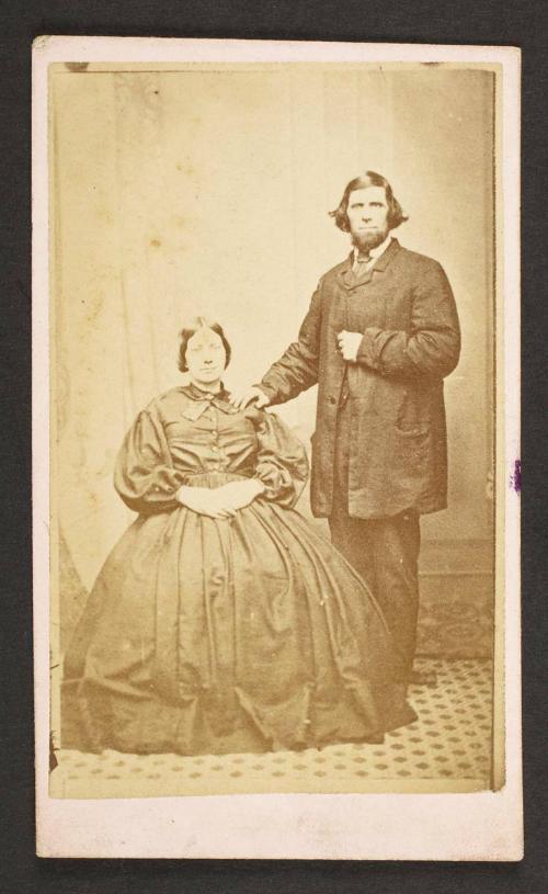 Unknown sitters  [portrait of a seated woman and standing man, with his right hand on woman's left shoulder]