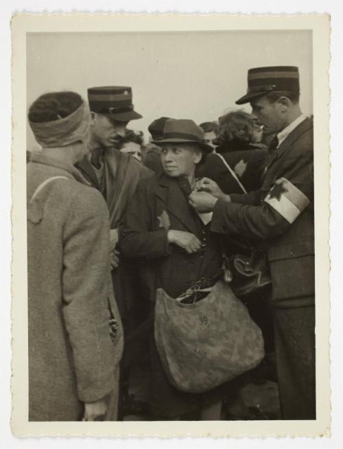 Ghetto resident being tagged by ghetto police for deportation