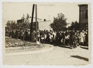 Mass deportation led by ghetto officials, approaching corner
