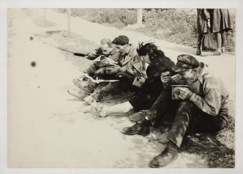 Ghetto residents eating from pails

