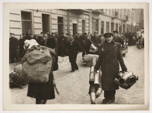 Man carrying bundles of pipes