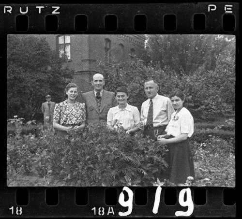 Two men and three women, with officer in the background