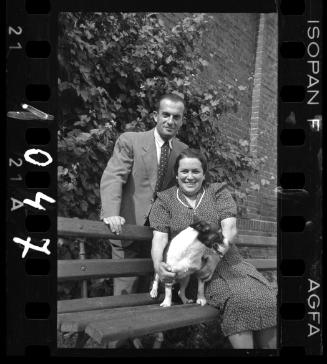 Couple with a dog on a bench