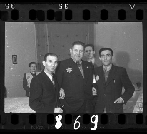 Jewish police officer and two friends smiling for the camera at a social gathering