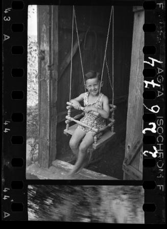 A girl in a doorway swing
