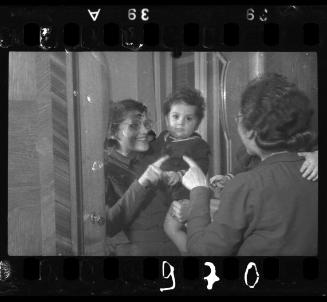 Mother and a baby looking into the mirror