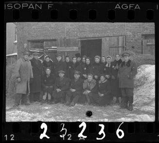 Workers of the Transport Department outside the entance to a stable
