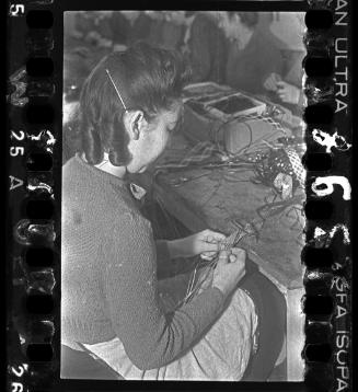 Woman plaiting decorative bands in a workshop ("ressort") in the ghetto
