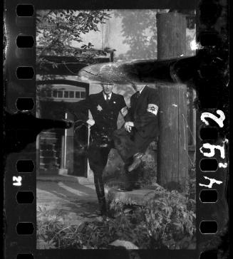 Two Jewish policemen posing in a courtyard